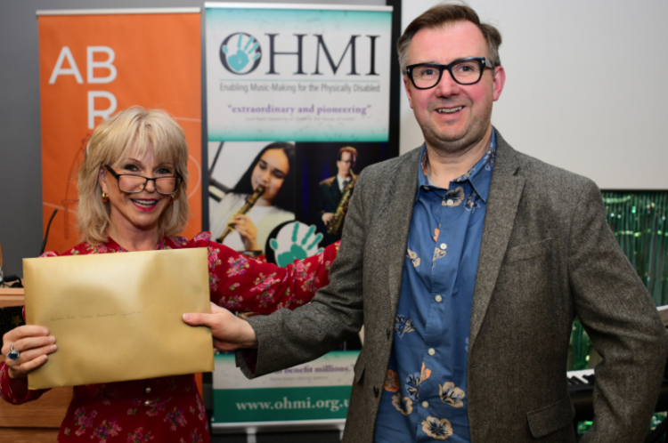 Trombonist, educator and Rath customer Willie McLean receives the OHMI Award from Toyah Willcox